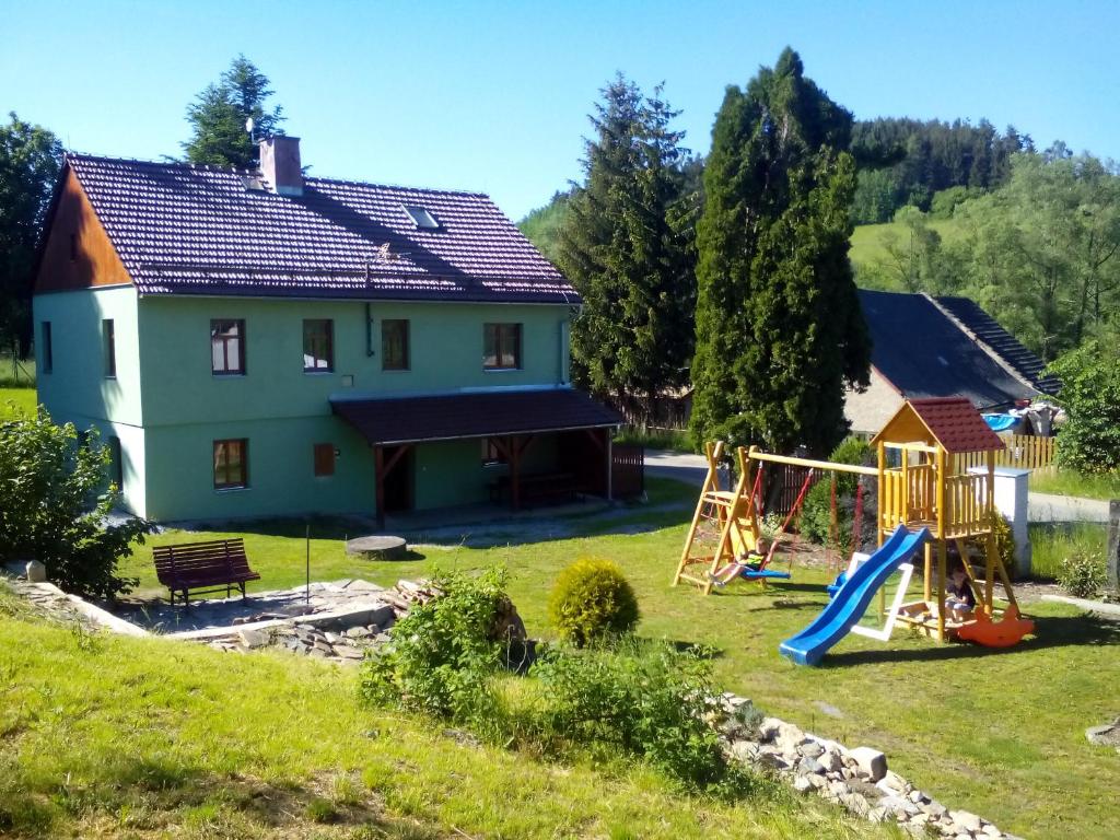 a house with a yard with a playground at Chalupa Hořice na Šumavě in Hořice na Šumavě