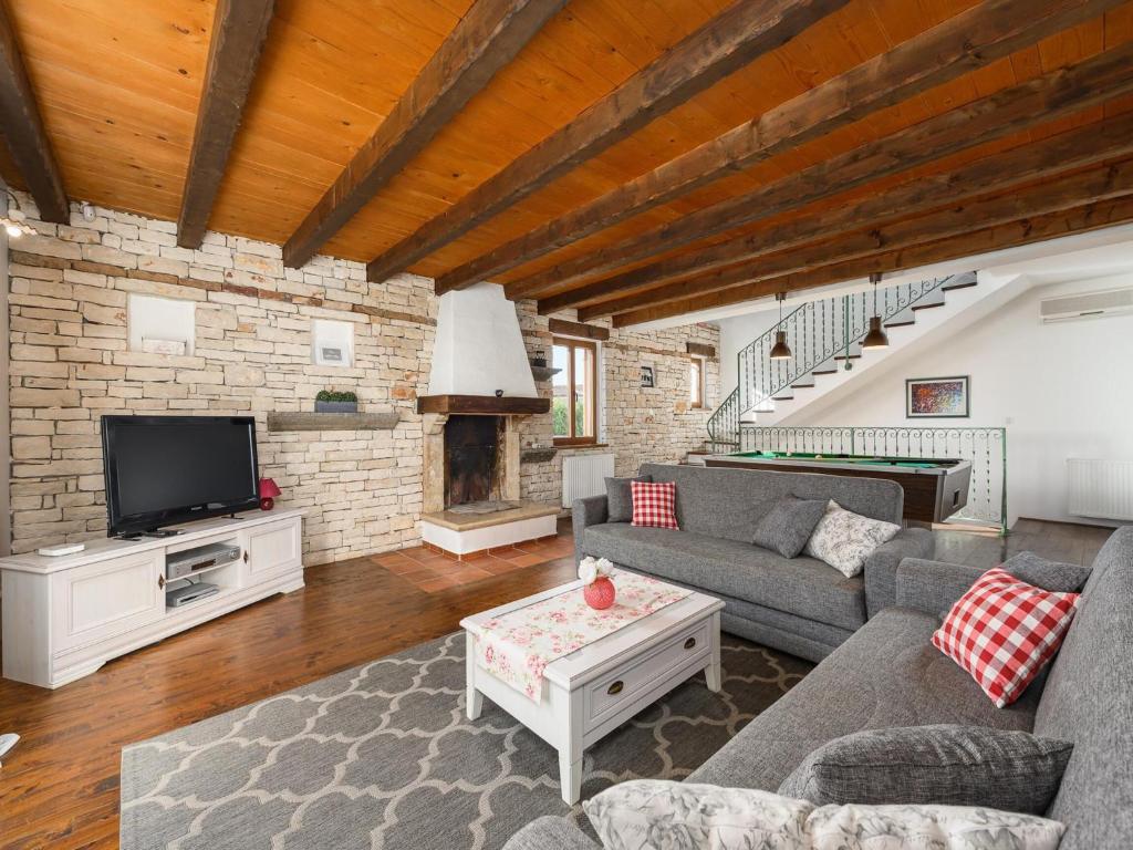 a living room with a couch and a tv at Villa in Sveti Lovrec near Ski Resort in Radetići
