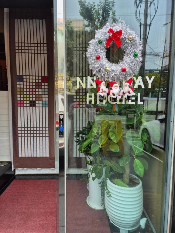 a window with a christmas wreath and a plant at New Day Hotel Gangnam in Seoul