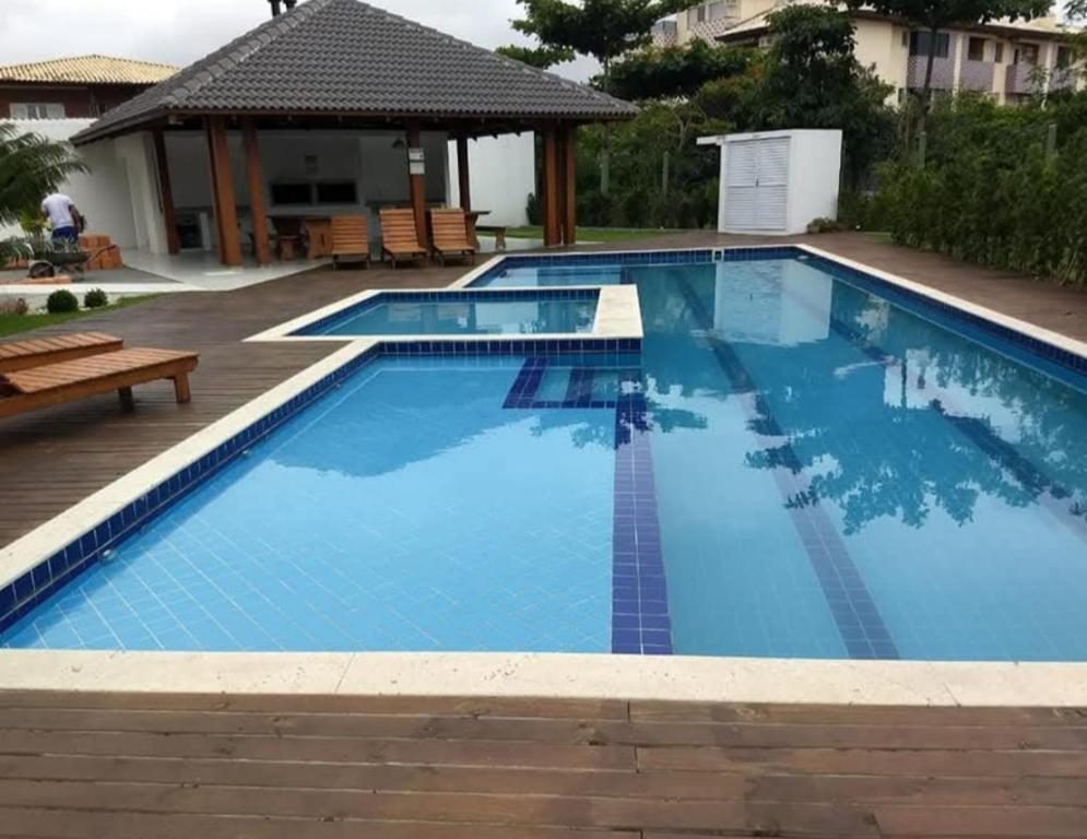 a large swimming pool with blue water at Refúgio Campodoro in Florianópolis