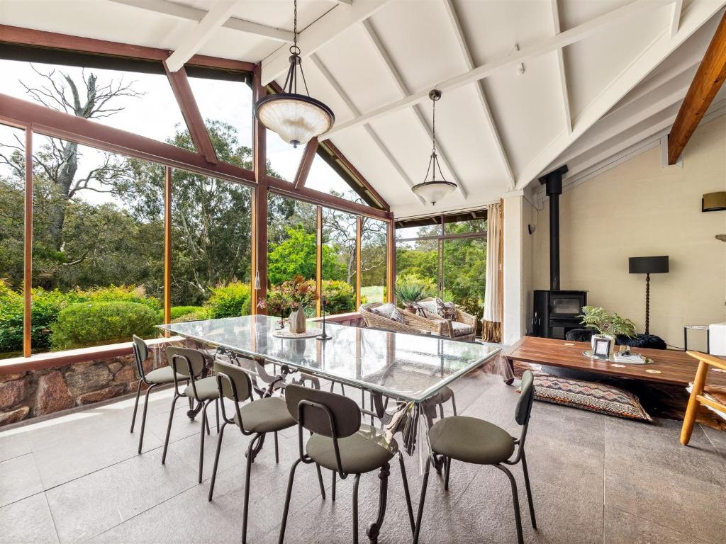 a dining room with a glass table and chairs at Shawlilly Stay in Margaret River Town