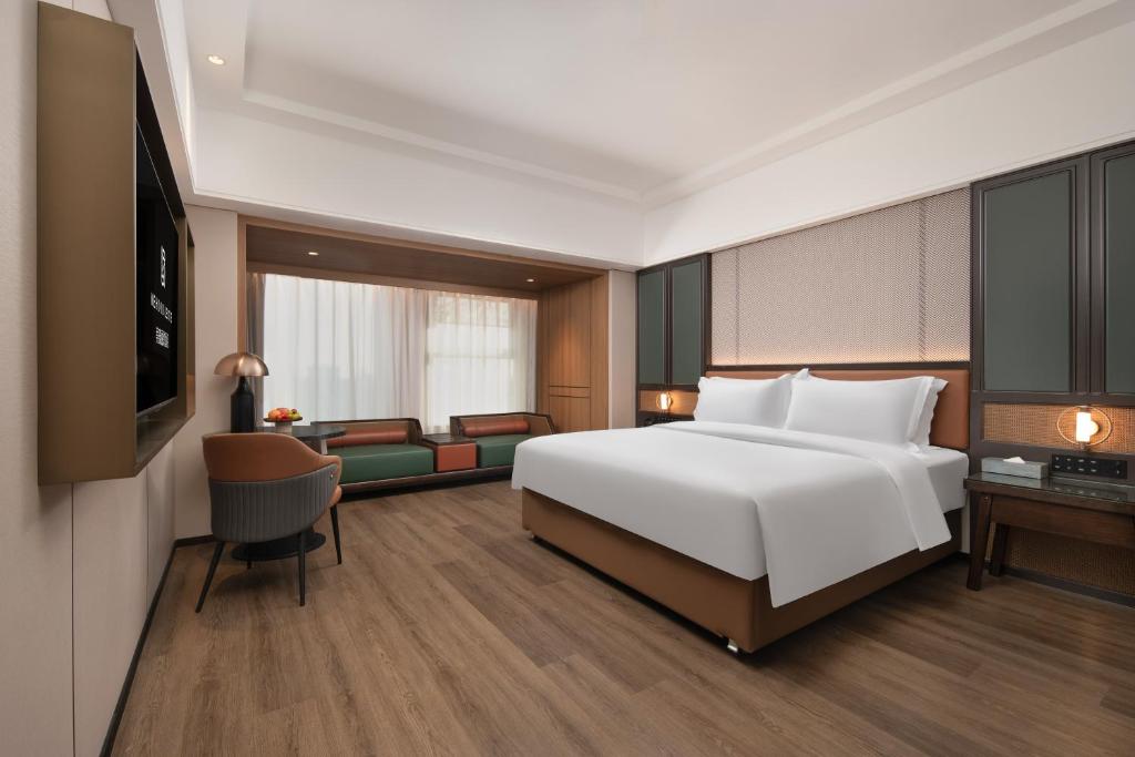 Postel nebo postele na pokoji v ubytování Mehood Lestie Hotel Dongguan Chang'an