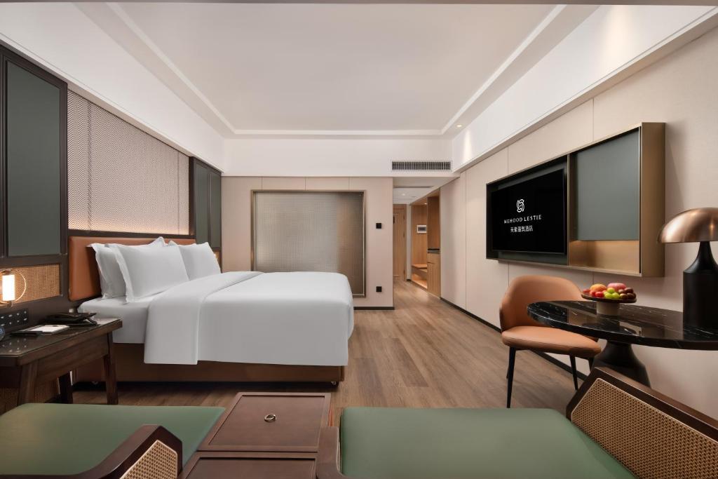Postel nebo postele na pokoji v ubytování Mehood Lestie Hotel Dongguan Chang'an