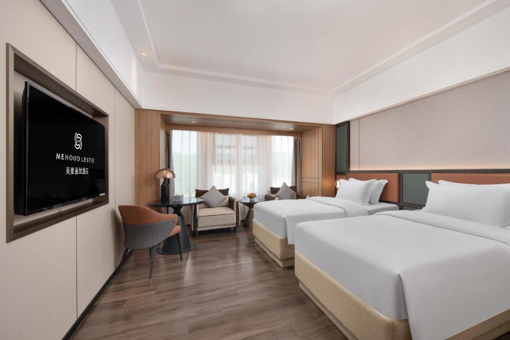 Postel nebo postele na pokoji v ubytování Mehood Lestie Hotel Dongguan Chang'an