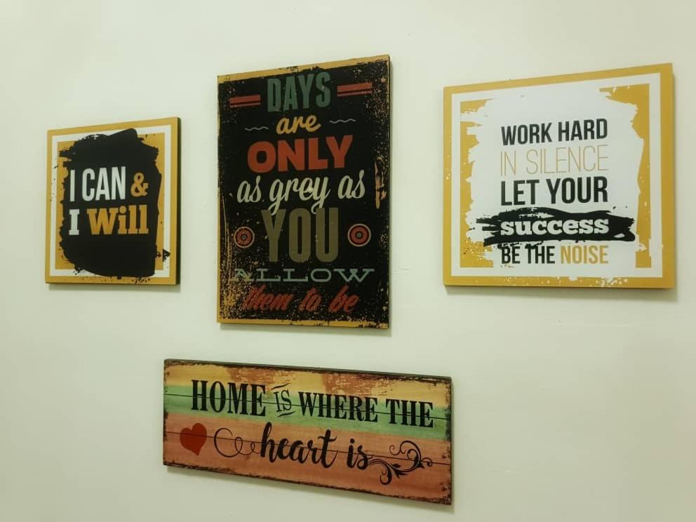 a group of four pictures hanging on a wall at Chek Embun Homestay in Padang Besar