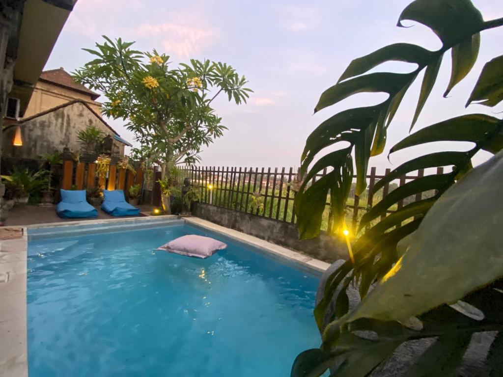 a swimming pool with a pink pig in the water at Mahesa House by SHM in Ubud