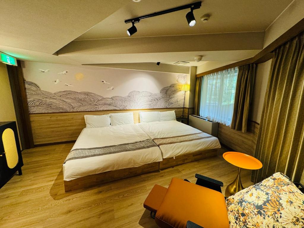 Postel nebo postele na pokoji v ubytování Sengokuhara Onsen Hotel