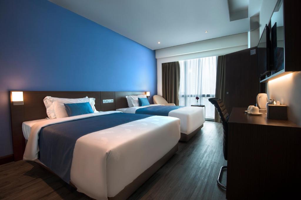 Postel nebo postele na pokoji v ubytování Astana Wing - Riverside Majestic Hotel