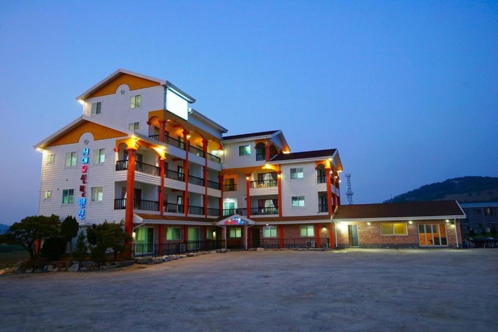 a large building is lit up at night at Gyeokpo Seohae Oceanville Pension in Chungmak-tong
