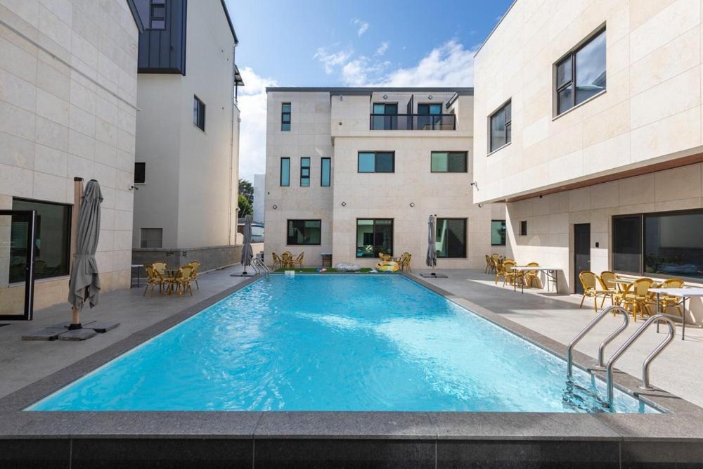 a large swimming pool in front of a building at Gangneung Stay in Gangneung in Gangneung