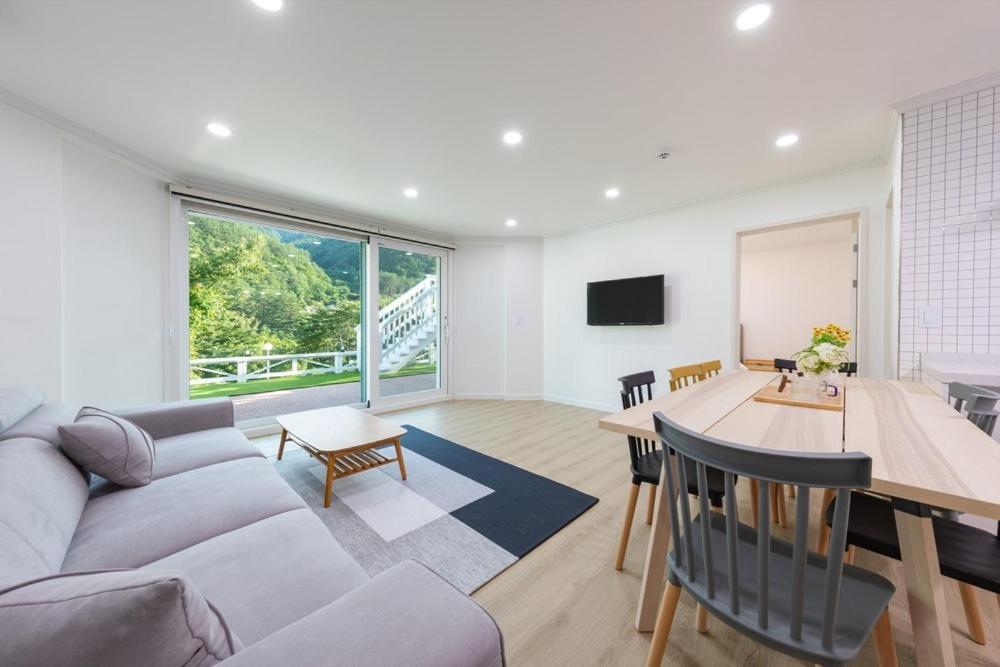 a living room with a couch and a table at Gangneung Chunja Yeoinsook in Gangneung