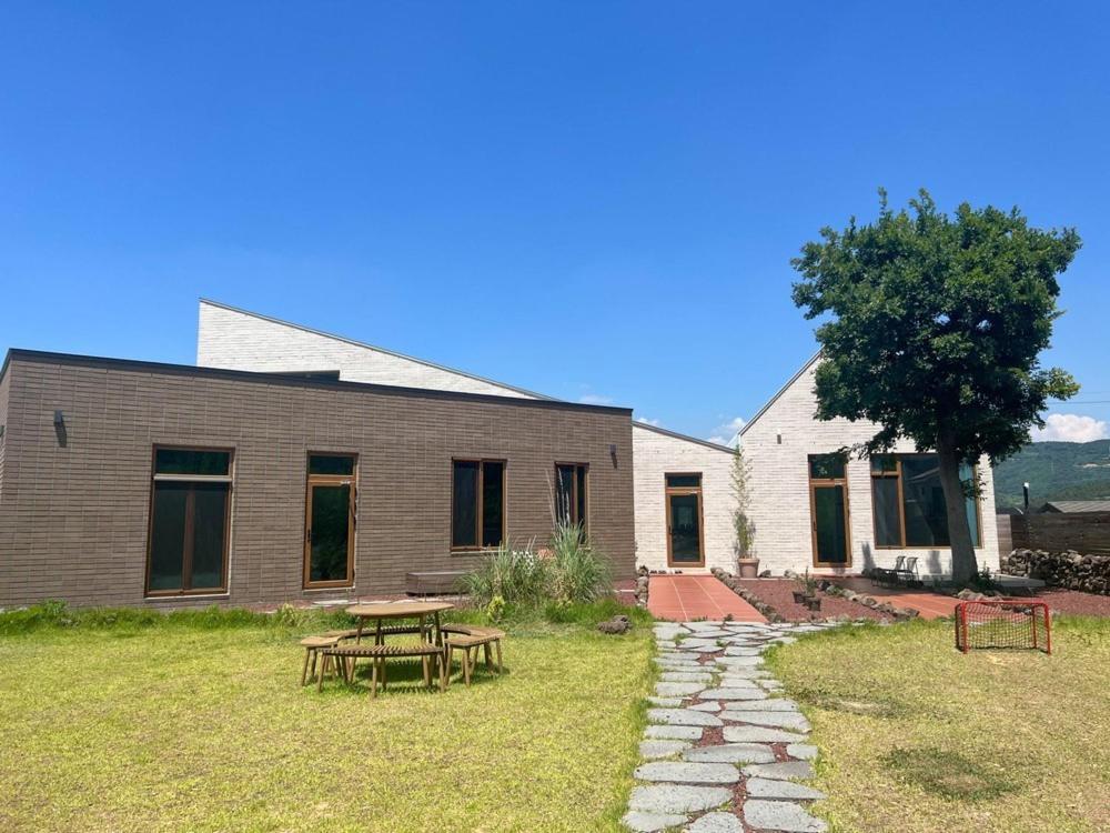 a house with a picnic table in the yard at Mijeok Gonggam and Soso Gonggam Dokchae Pool Villa in Yeongam