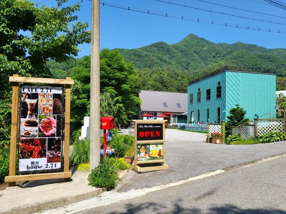 two signs on the side of a street at Gapyeong House 2 71 Pension in Kŏjŏbi