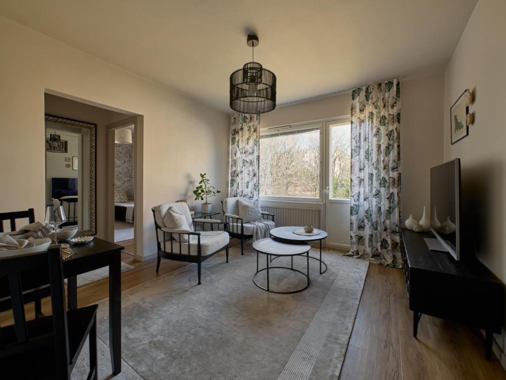 a living room with a couch and a table at 50s Atmospheric Suite in Turku