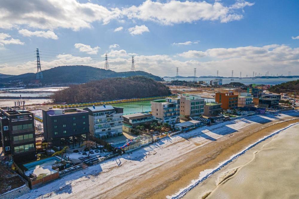 an aerial view of a city with a beach and buildings at Daebudo Ara Pension in Ansan
