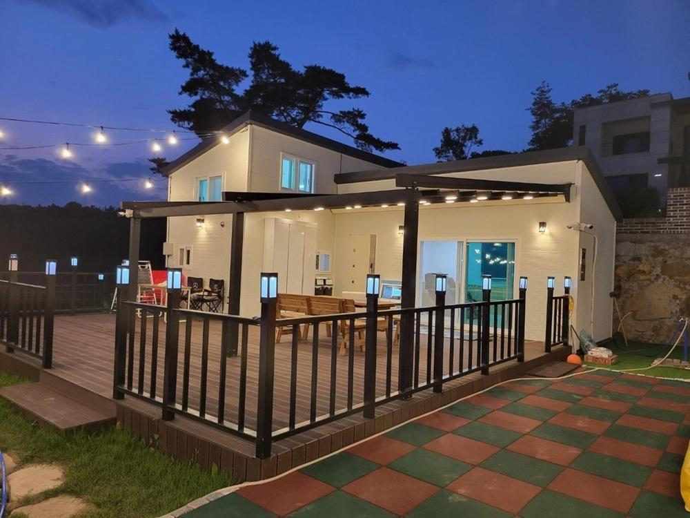 a house with a deck with a fence at A Great View Kids Pool Villa Pension in Miryang