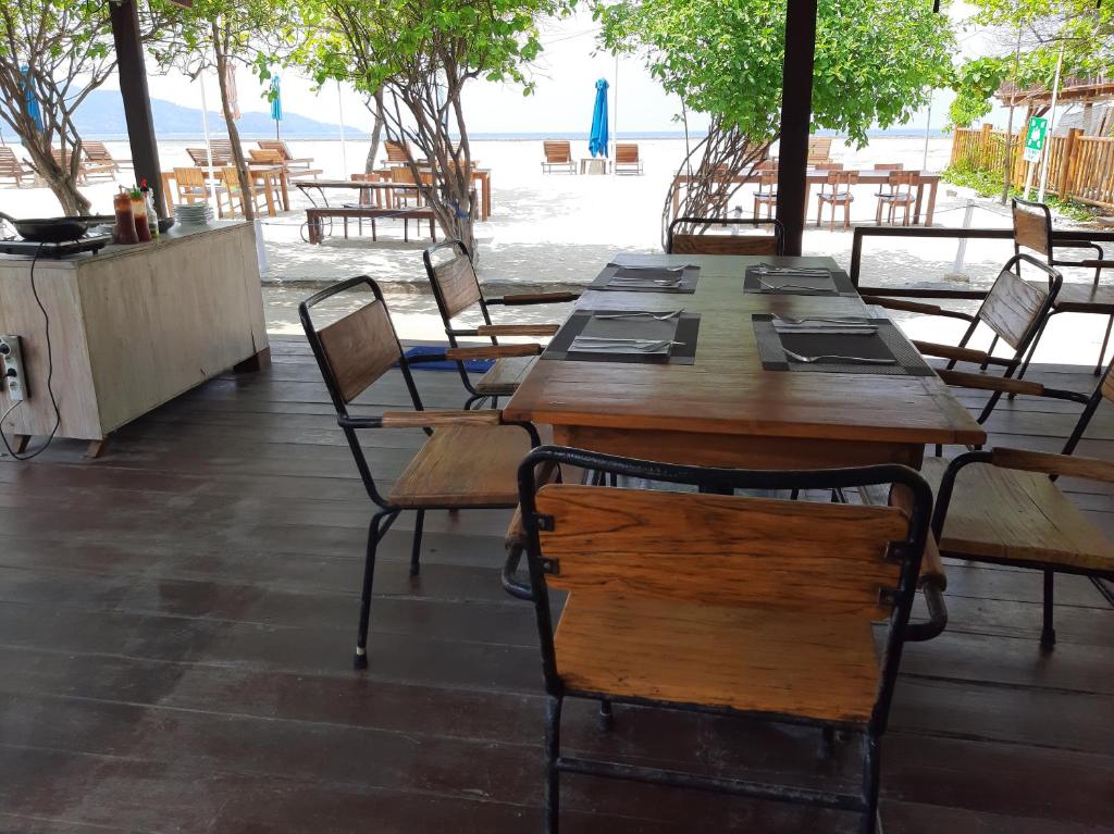 a group of tables and chairs in a restaurant at Mola2 Resort Gili Air in Gili Islands