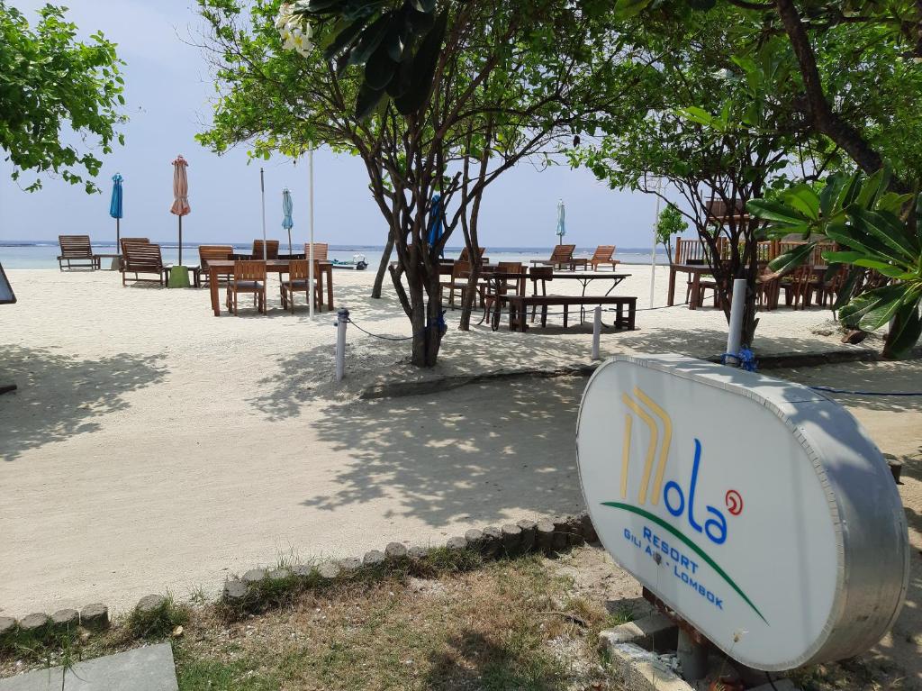 a toilet on the beach with tables and chairs at Mola2 Resort Gili Air in Gili Islands