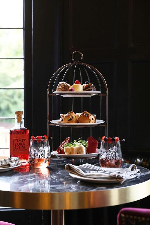 a table with three plates of food on a shelf at DoubleTree by Hilton Hotel Newcastle International Airport in Newcastle upon Tyne