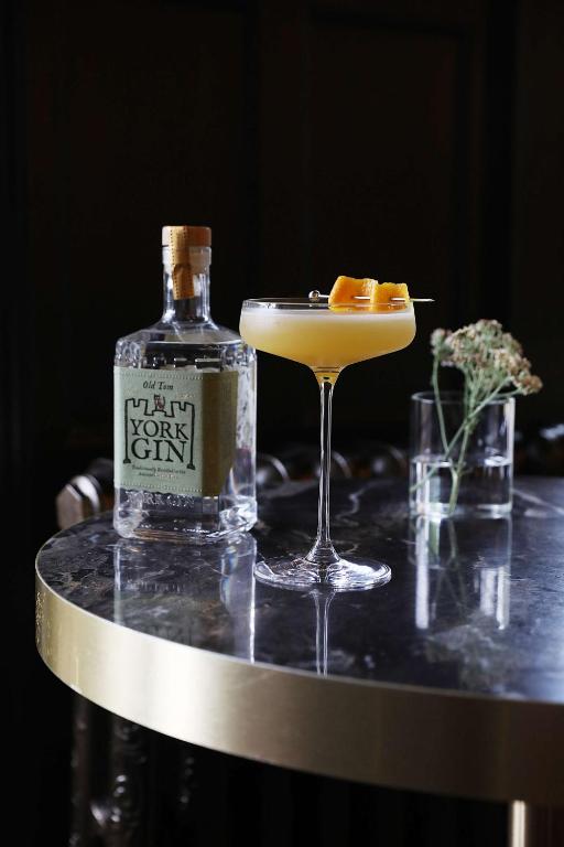 a bottle of gin sitting next to a martini and a drink at DoubleTree by Hilton Hotel Newcastle International Airport in Newcastle upon Tyne
