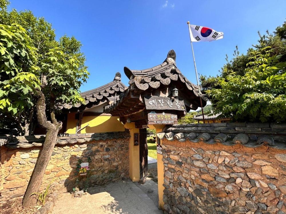 a building with a flag on top of it at Sanencheong Namsayedamchon Yedam Hanok Stay in Sancheong