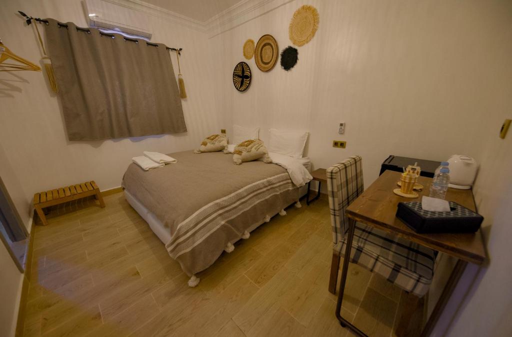 Postel nebo postele na pokoji v ubytování Hotel Riad Amlal