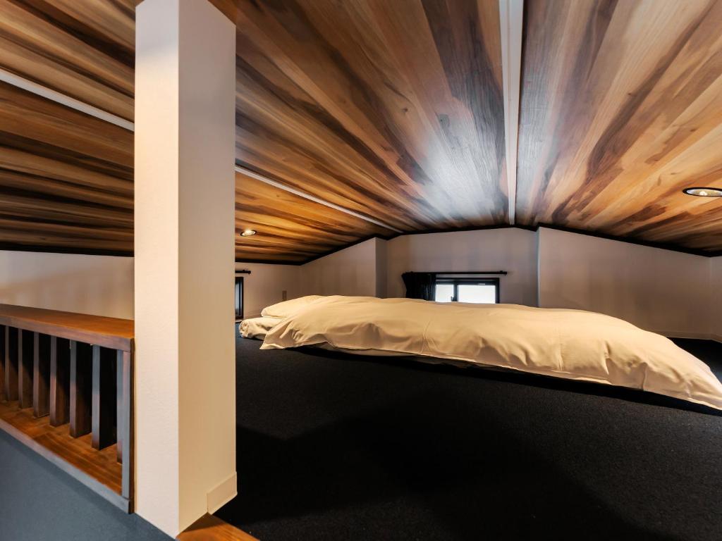 Postel nebo postele na pokoji v ubytování Myoko Onsen cottage Ajisai