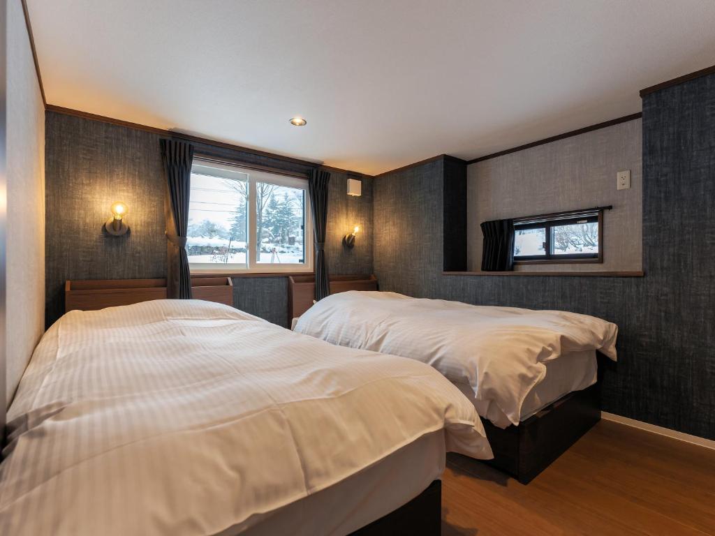 Postel nebo postele na pokoji v ubytování Myoko Onsen cottage Ajisai