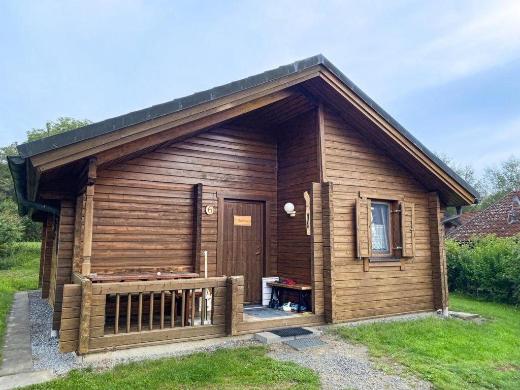 a log cabin with a porch and a door at Ferienhaus Nr 6, Typ A, Feriendorf Jägerpark, Bayerischer Wald in Prackenbach