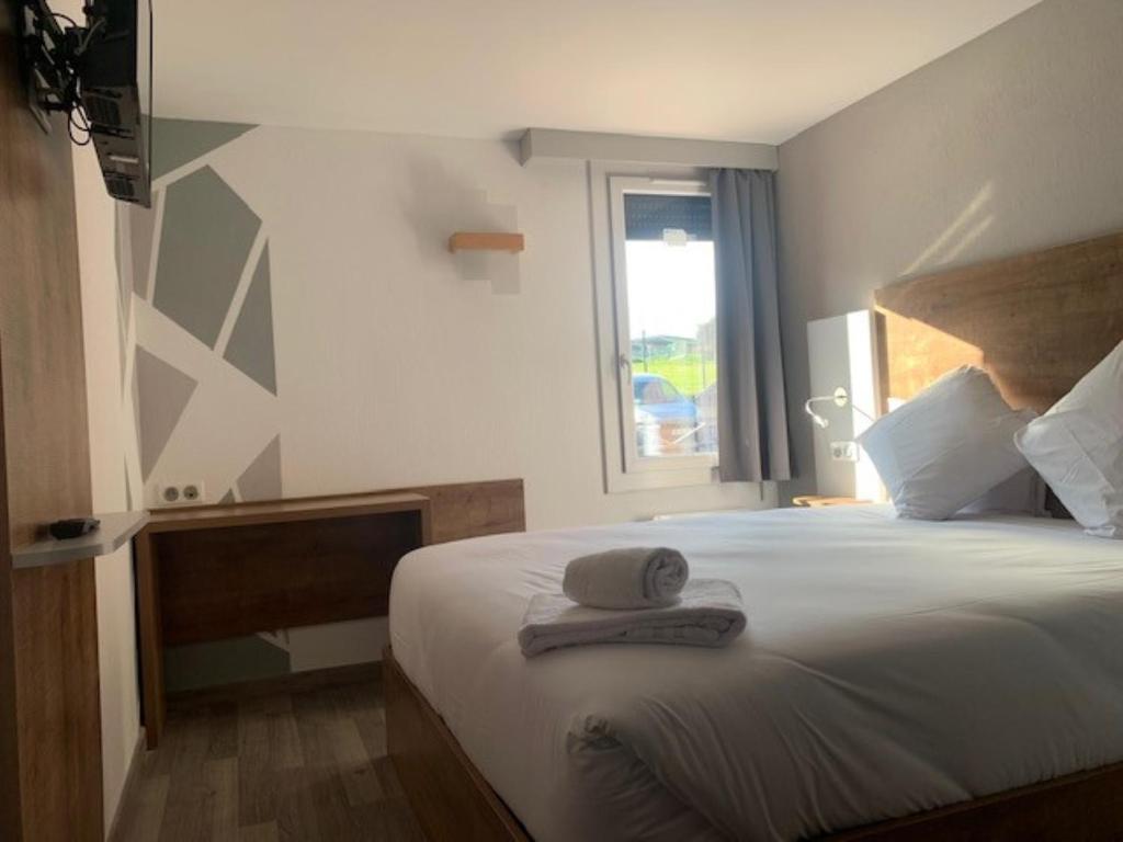 Postel nebo postele na pokoji v ubytování Val Hôtel Montbéliard Sud