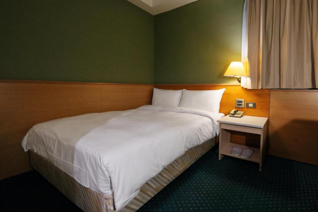 Postel nebo postele na pokoji v ubytování 天津大酒店 Vagus Hotel