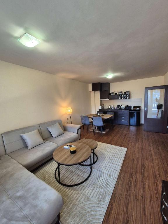 a living room with a couch and a table at Apartment Melania in Complex Royal Towers in Bansko