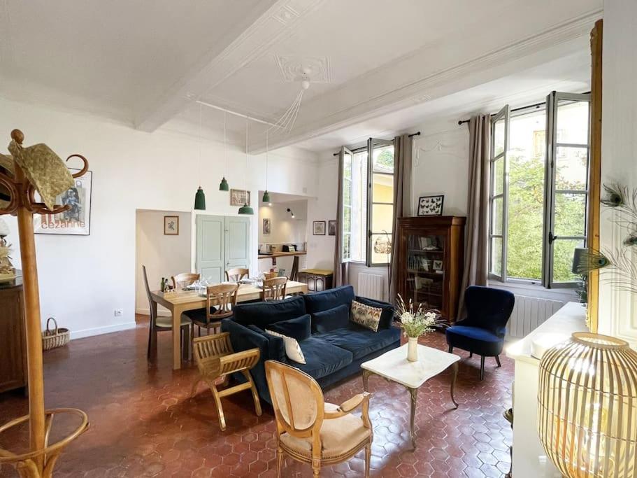 un salon avec un canapé bleu et une table dans l'établissement Appart d exception 2 chambres quartier Mazarin, à Aix-en-Provence