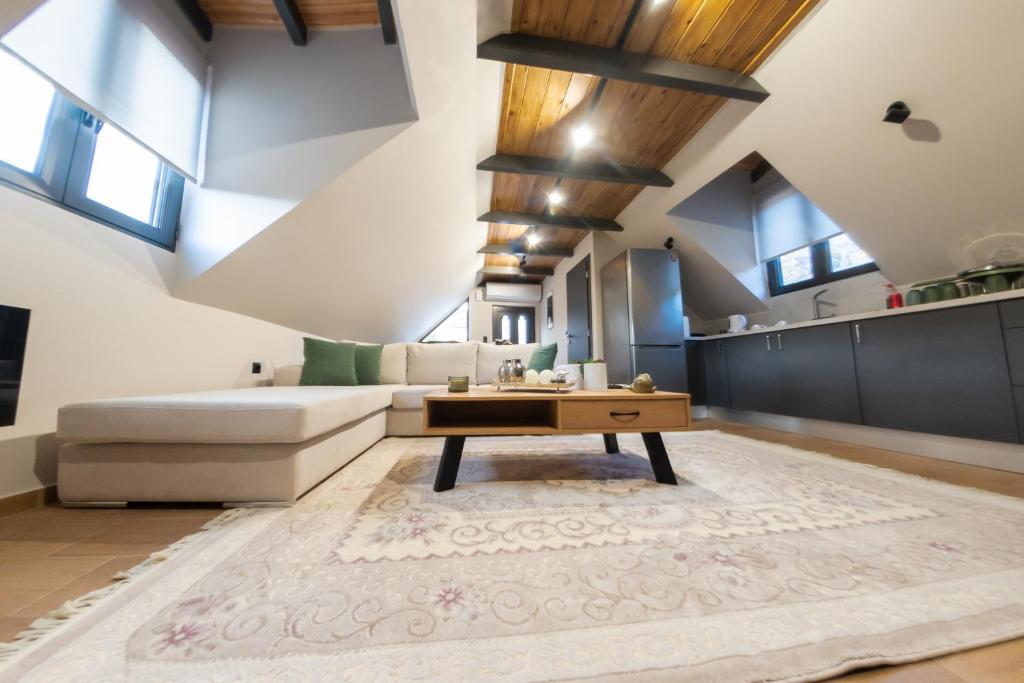 a living room with a couch and a coffee table at Roof Mountain Top in Kerpiní