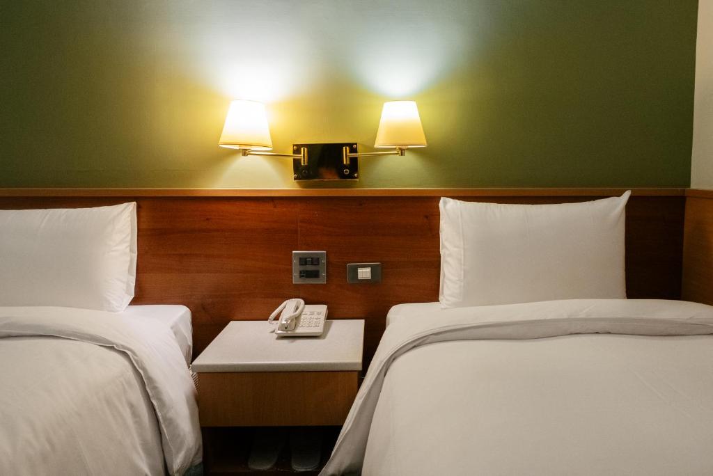 Postel nebo postele na pokoji v ubytování 天津大酒店 Vagus Hotel