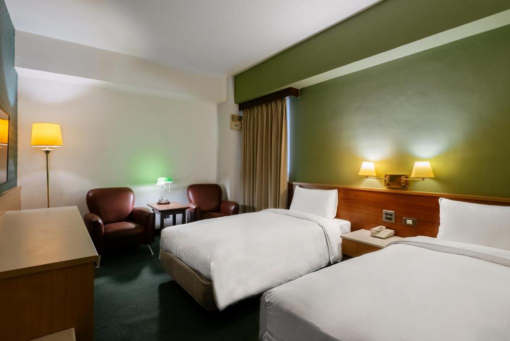 Postel nebo postele na pokoji v ubytování 天津大酒店 Vagus Hotel