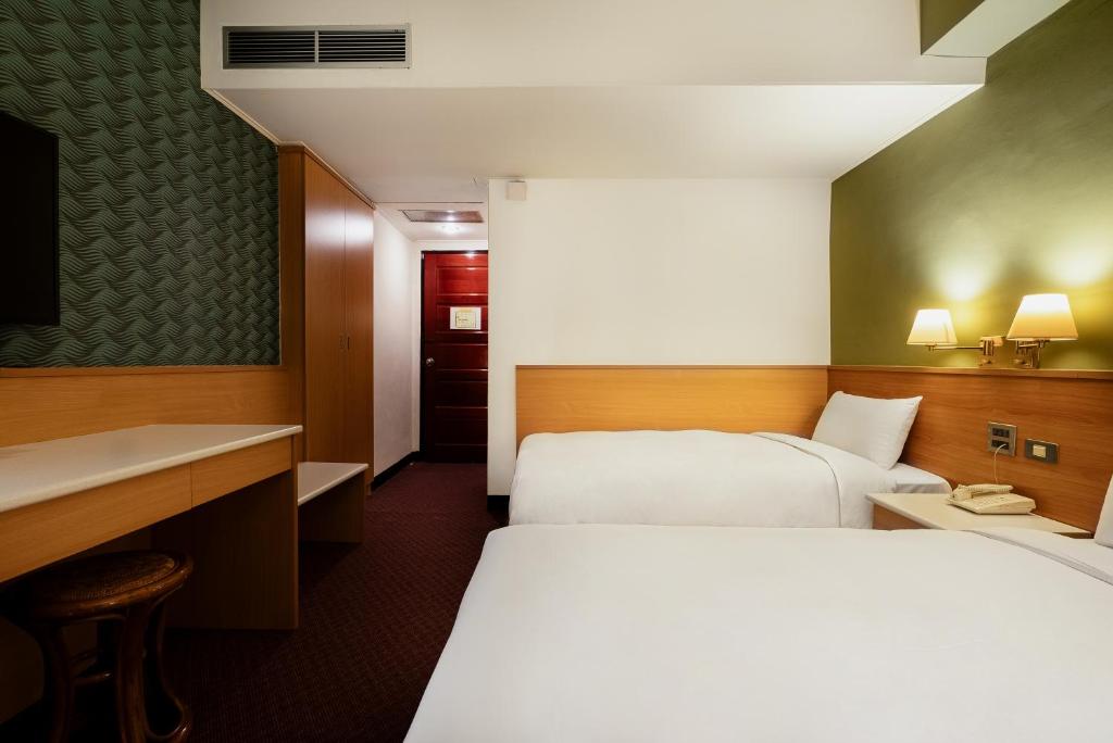 Postel nebo postele na pokoji v ubytování 天津大酒店 Vagus Hotel