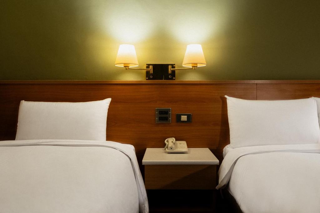 Postel nebo postele na pokoji v ubytování 天津大酒店 Vagus Hotel