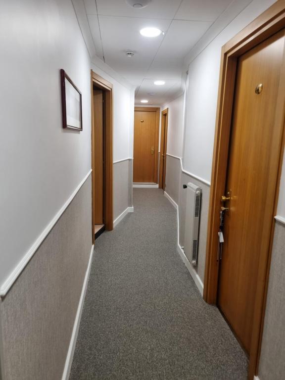 a hallway of an office building with a door and a hallway at Hotel Calypso in Ventimiglia