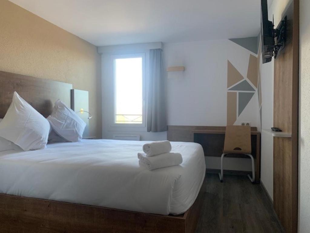 Postel nebo postele na pokoji v ubytování Val Hôtel Montbéliard Sud