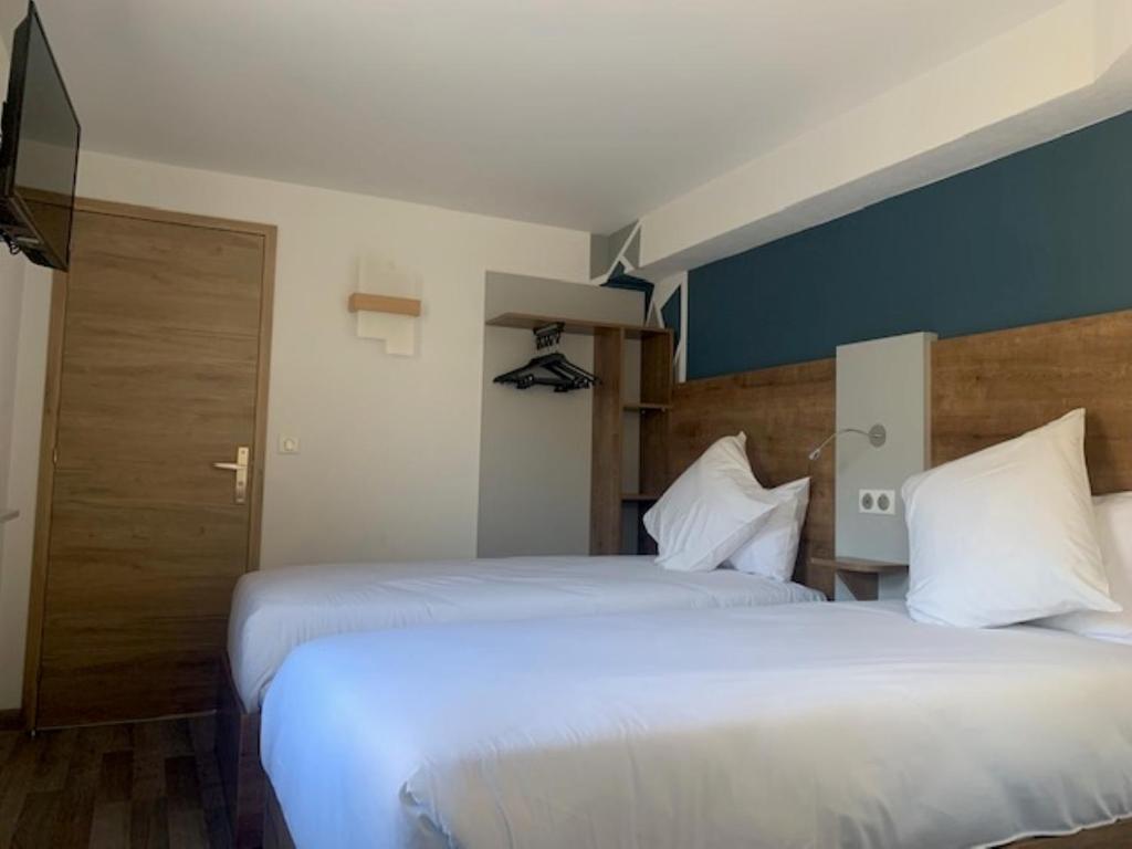 Postel nebo postele na pokoji v ubytování Val Hôtel Montbéliard Sud