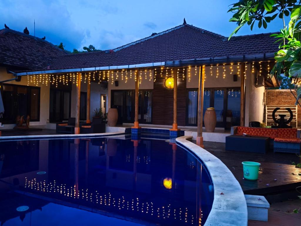 a villa with a swimming pool at night at The Dharma Lovina - Mountain, Sea & Sunset View - Private Villa w Starlink - 5br in Lovina