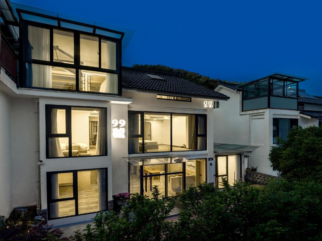 a large white building with illuminated windows at night at Care Cozy and Comfort in Hangzhou