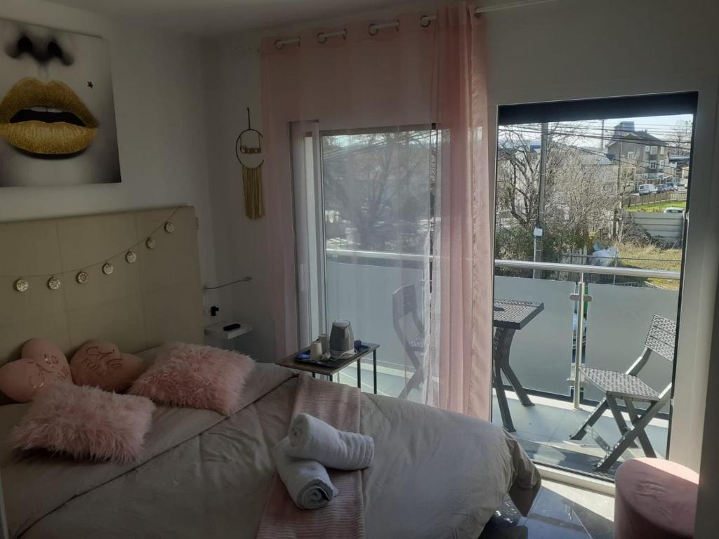 a bedroom with a bed with a view of a balcony at Love Room Charme in Tremblay En France