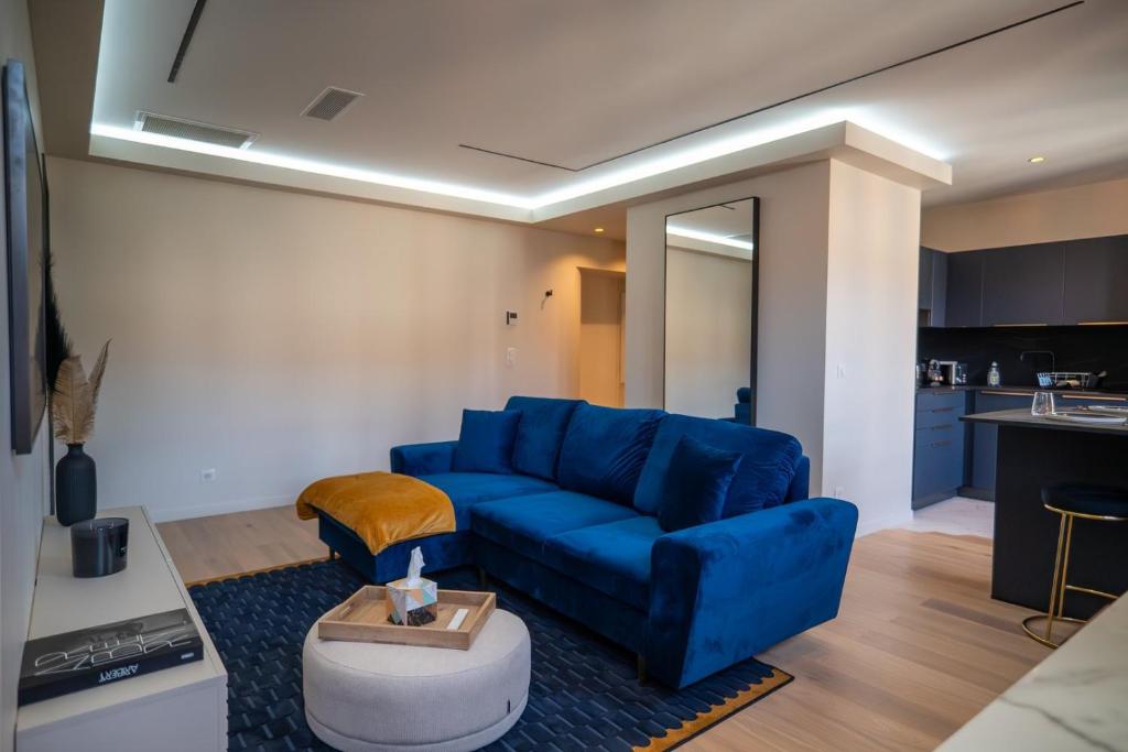 un salon avec un canapé bleu et une cuisine dans l'établissement GuestReady - Lovely Getaway, à Nice