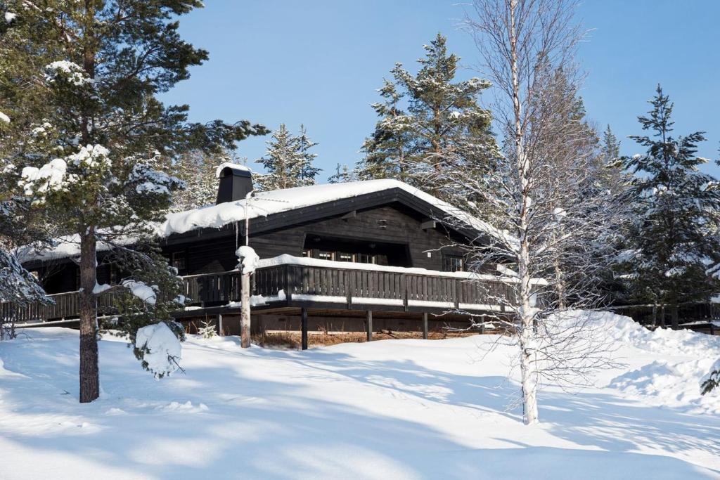 a log cabin with snow on the roof at Sauna | Engine heater | Wood stove | Terrace in Lofsdalen
