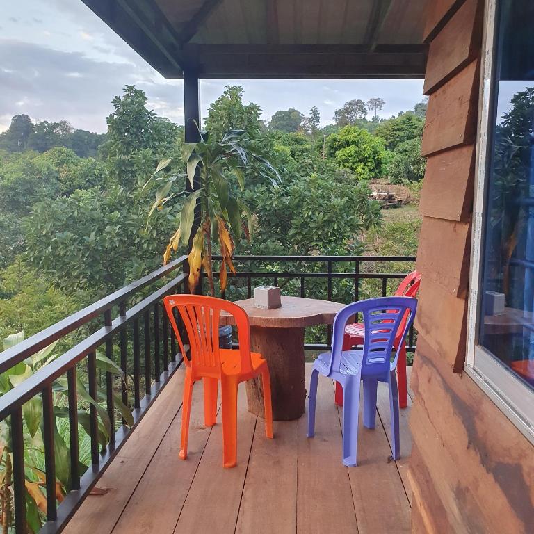 three chairs and a table on a balcony at Banlung Mountain View Treks & Tours in Banlung
