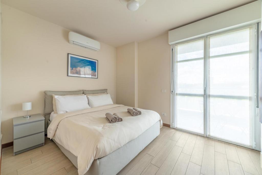 una camera da letto con un letto e una grande finestra di COS54 - Exclusive Apartment - a Milano
