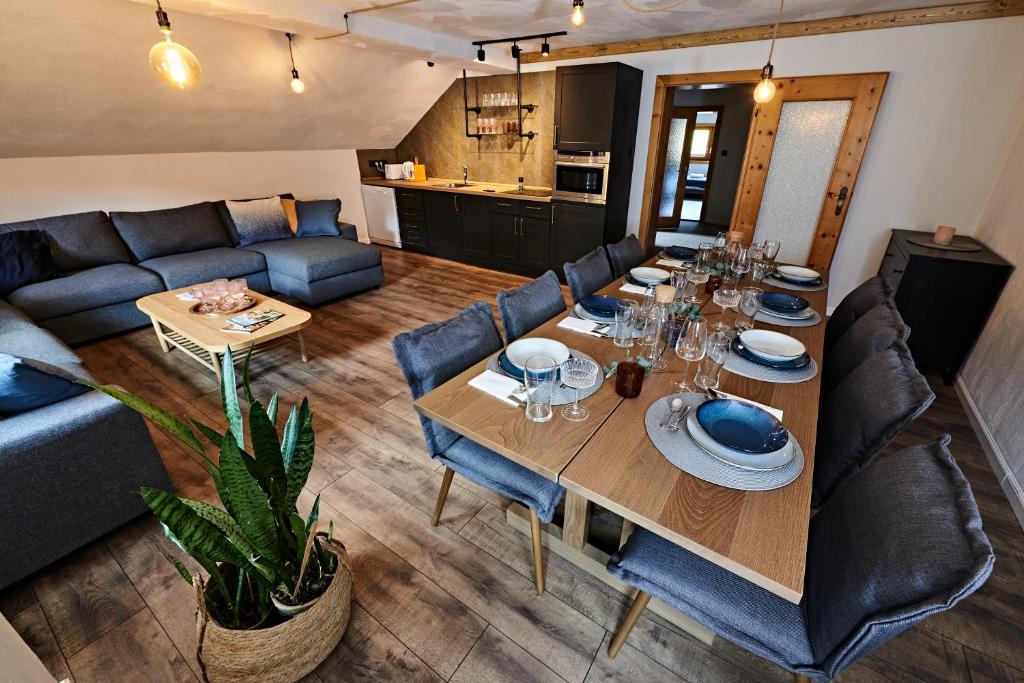 a living room with a table and a couch at Spago am Hochkönig in Mühlbach am Hochkönig