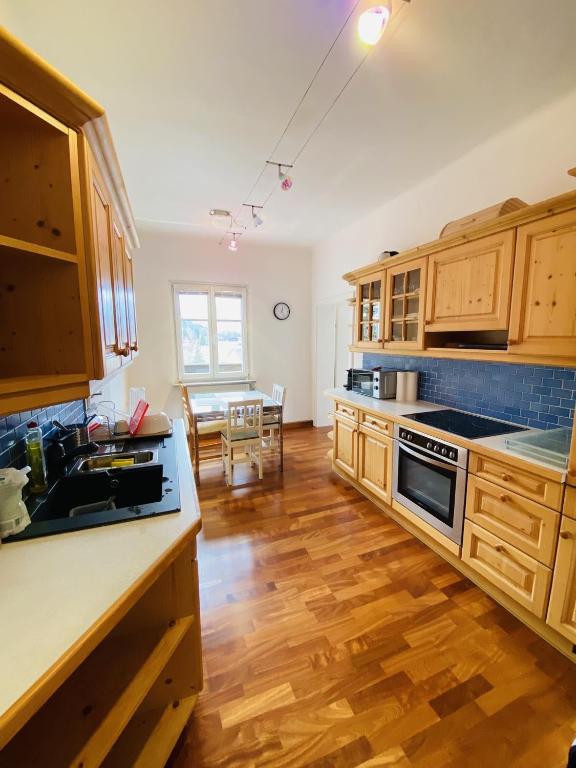 a kitchen with wooden cabinets and a counter top at Appartement Cseho in Murau